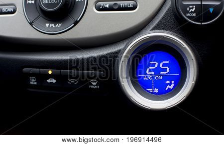 Digital controller display of air conditioner in car interior with twenty-five temperature climate adjustment. selective focus. Automotive part concept.