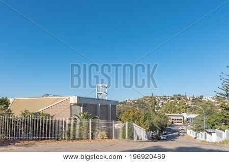 WINDHOEK NAMIBIA - JUNE 15 2017: A street scene with the Dutch Reformed Church Eros businesses and houses in Eros a suburb of Windhoek the capital city of Namibia