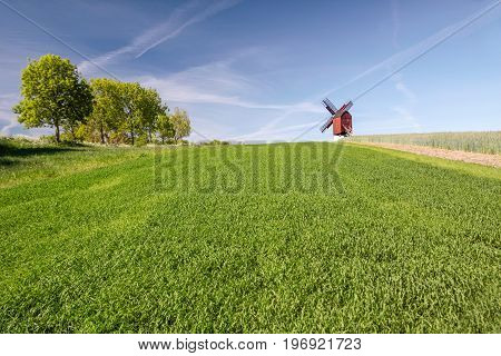 Traebene Mill Windmill with green fields in the village of Melsted Bornholm Denmark