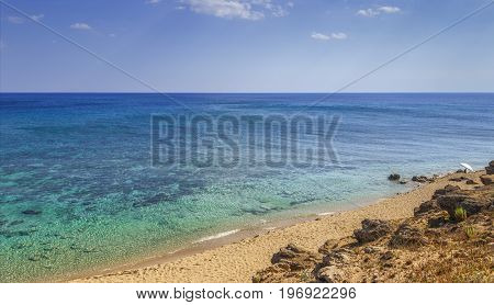 The most beautiful beaches of Italy: Campomarino dune park.Summer relax:umbrella isolated between sea dunes,Taranto (Apulia). The protected area extends along the entire coast of the town of Maruggio.Summertime beach.The coastline is characterized by a su