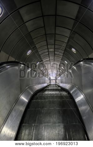 Empty escalator on the London underground looking down.