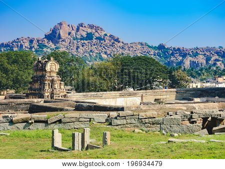 View of ancient ruins on Hemakuta hill in Hampi, Karnataka, India. Landscape with unique mountain formation with amazing stones tropical nature and temple. UNESCO World Heritage Site