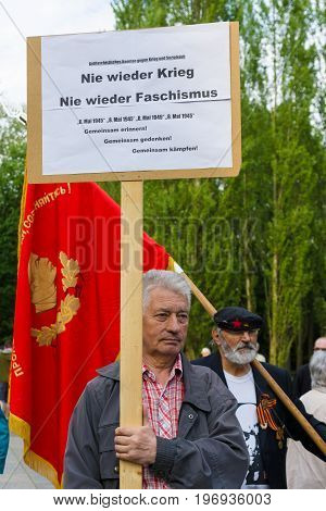 BERLIN - MAY 08 2015: Victory in Europe Day. Treptower Park. Communist activists at the memorable event. Text in German: No War! No fascism!