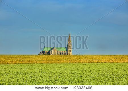 Image of the Cathedral of Our Lady of Chartres seen from outside of the city above the fields of cereals which surround the locality.This is a very famous Gothic cathedral which contains original stained glass from the 13th century.