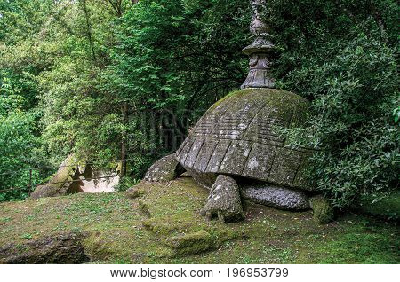 Bomarzo, Italy - May 20, 2013. View of sculpture amidst the vegetation in the Park of Bomarzo. Also known as Park of Monsters, it was created to surprise the visitor with surrealistic works in stone. Lazio region, central Italy