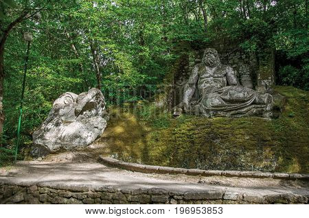 Bomarzo, Italy - May 20, 2013. View of sculpture amidst the vegetation in the Park of Bomarzo. Also known as Park of Monsters, it was created to surprise the visitor with surrealistic works in stone. Lazio region, central Italy