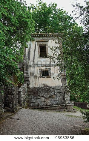Bomarzo, Italy - May 20, 2013. View of house amidst the vegetation in the Park of Bomarzo. Also known as Park of Monsters, it was created to surprise the visitor with surrealistic works in stone. Lazio region, central Italy