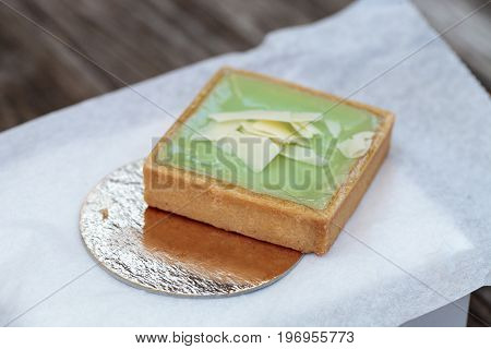 Green Keylime Tart Pastry With A Cookie Crust And White Chocolate Flakes