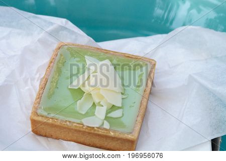 Green Keylime Tart Pastry With A Cookie Crust And White Chocolate Flakes