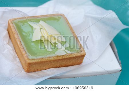 Green Keylime Tart Pastry With A Cookie Crust And White Chocolate Flakes
