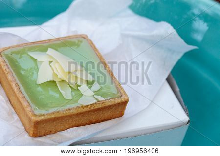 Green Keylime Tart Pastry With A Cookie Crust And White Chocolate Flakes