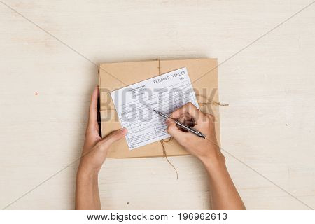 Top view of deliveryman making notes in 