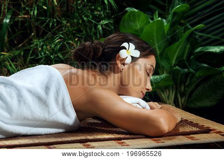 portrait of young beautiful woman relaxing in spa environment