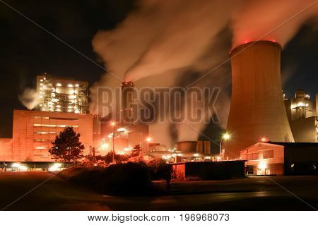 an old coal power plant at night with long time exposure