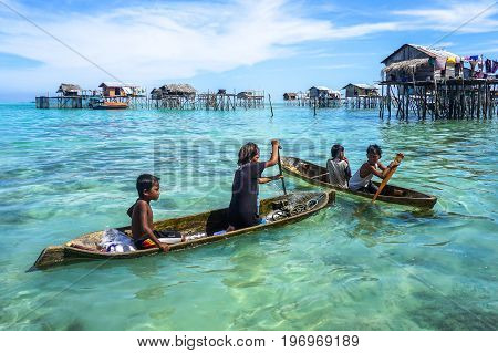Semporna,Sabah,Malaysia-Apr 24,2017:Sea Gypsy kids on an unique handmade boat in Bodgaya island,Semporna,Sabah,Borneo,Malaysia.