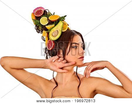 Hair and facial mask from fresh fruits for woman concept. Woman in profile is testing new diet with vitamins for hair. Woman is resting in a spa salon.