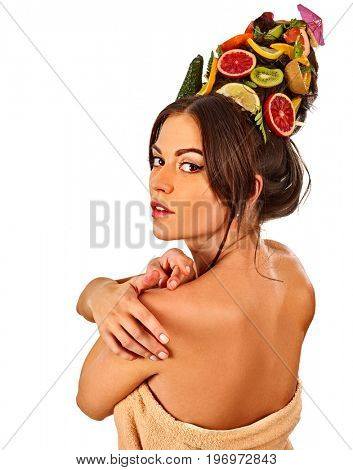 Hair and facial mask from fresh fruits for woman concept. Woman in profile is testing new diet with vitamins for hair. Woman is resting in spa salon on isolated. Bare shoulders back view.