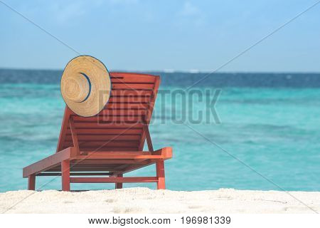 Summer paradise with white chair and colorful umbrella in Maldives Island