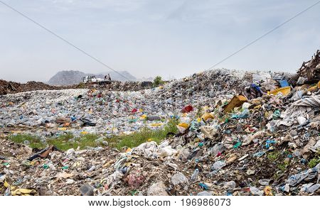 uncontrolled waste dumping landfill with open burning site