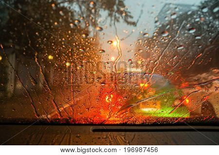 raindrops and street light bokeh on wind shield