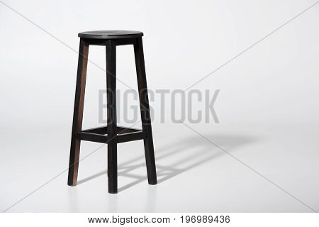 Studio Shot Of Classic Black Tall Wooden Barstool Standing On White