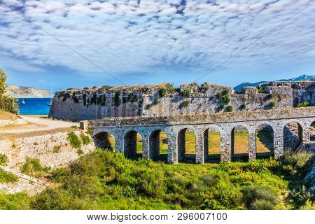 Venetian fort castle Methoni on the Greek Peninsula Peloponnese. The picturesque ancient viaduct connects the gates of the fortress with the road. The concept of active, photo and historical tourism
