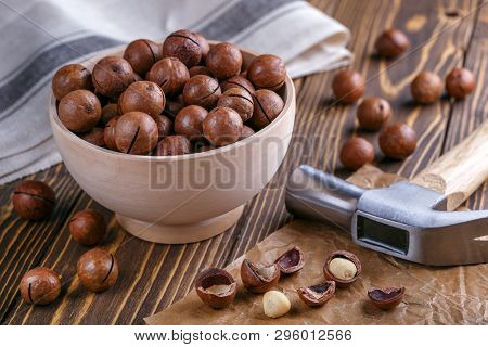 Macadamia Nuts In Wooden Bowl On Desk. Natural Healthy Food.