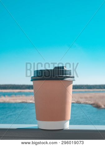 Paper Cup Of Coffee On Natural Morning Background. Film Effect.