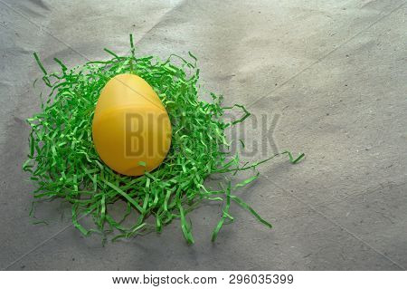 Big Yellow Eggin Green Nest On Craft Paper