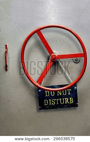 Do Not Disturb Warning Sign Plate Hanging On A Hermetic Bomb Shelter Armored Door