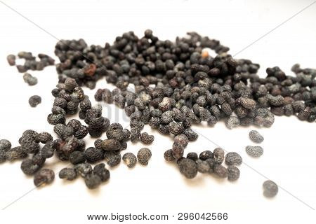 Macro Shot Of Dried Pile Of Poppy Seeds Isolated On White Background
