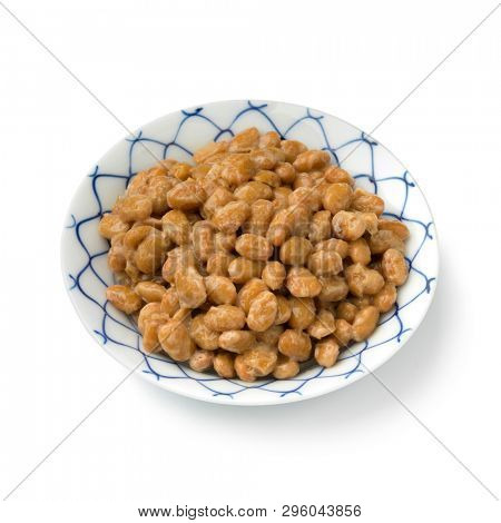 Bowl with traditional Japanese fermented soybeans called natto isolated on white background