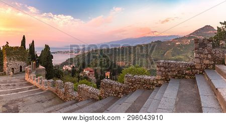 Panoramic View Of Smoking Snow-capped Mount Etna Volcano At Sunrise, As Seen From Taormina, Sicily