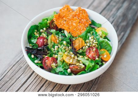 Healthy Food Concept. Fresh Sald Of Cherry Tomatoes, Mung Bean, Carrot Chips And Flat Bread On Woode