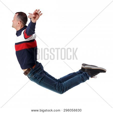 Side view of man in zero gravity or a fall. guy is flying, falling or floating in the air.   side view of person.  Isolated over white background. The guy in jeans soars in the air or water.