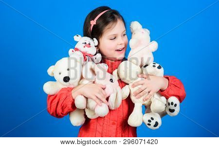 Happy Childhood. Little Girl Play With Soft Toy Teddy Bear. Lot Of Toys In Her Hands. Childhood Conc