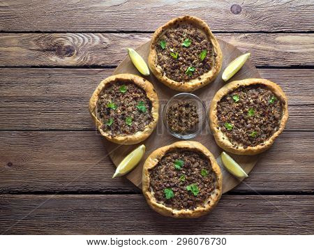 Arabic Meat Sfiha Over A Wooden Table. Top View Of Arabic Esfiha.