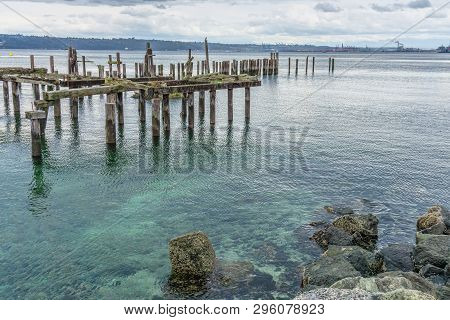 A View Of Decaying Pilings Along The Shore In Ruston, Washington Near Tacoma.