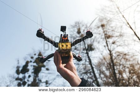 Pilot Racing Drone Holds In His Hand Fpv Copter Before Launching It. A Small High-speed Aircraft Wit