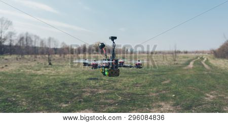 A Small Fpv Racing Drone Is Ready To Fly And Hovered Above The Ground Before The Race. Self-made Fly