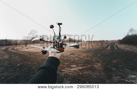 Pilot Racing Drone Holds In His Hand Fpv Copter Before Launching It. A Small High-speed Aircraft Wit