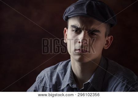 Closeup Portrait Of Young Man With Beret Hat. Very Serious Face Expression, Suspicious. Human Facial