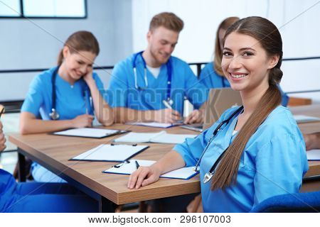 Medical Student With Groupmates In University Library