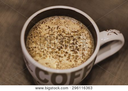Coffee With Chocolate, Cinnamon And Milk In A Cup Of White On A Dark Background