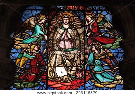 FLORENCE, ITALY - JANUARY 09, 2019: Virgin Mary surrounded by angels, stained glass window in Orsanmichele Church in Florence, Tuscany, Italy
