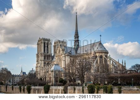 Caption/Description: Notre Dame Cathedral in Paris. Springtime view. of the side elevation with spire and rear flying butresses, taken from across the river Seine. 