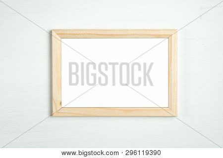 Wooden Frame On A White Wooden Background.