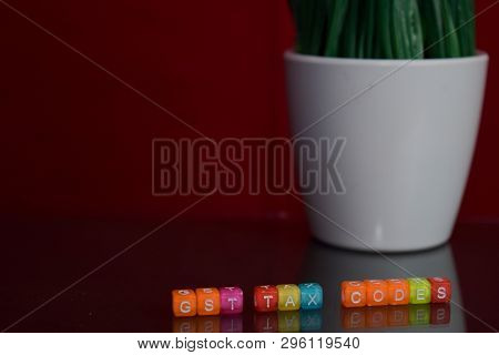 Gst Tax Codes Text At Colorful Wooden Block On Red Background. Desk Office And Education Concept