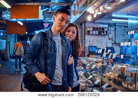 Happy Asian Couple Looking For Something Special At Chainese Market. They Are Pensive. A Lot Of Seaf