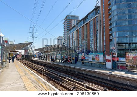 London, Uk - May 1, 2018: People Wait For The Train On Royal Victoria Dlr Station In Docklands Distr